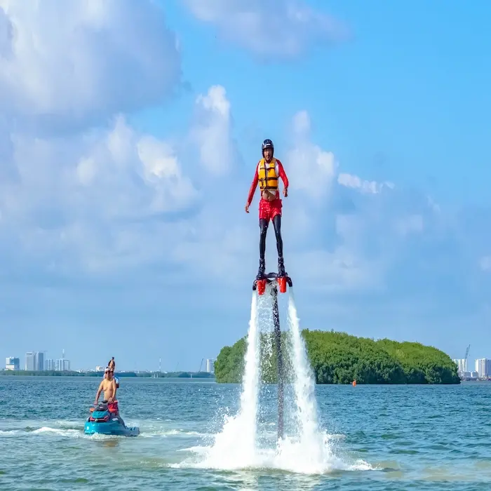 Adventurer enjoying the Cancun Flyboard Experience, flying above the waters of the Nichupte Lagoon in Cancun, Mexico